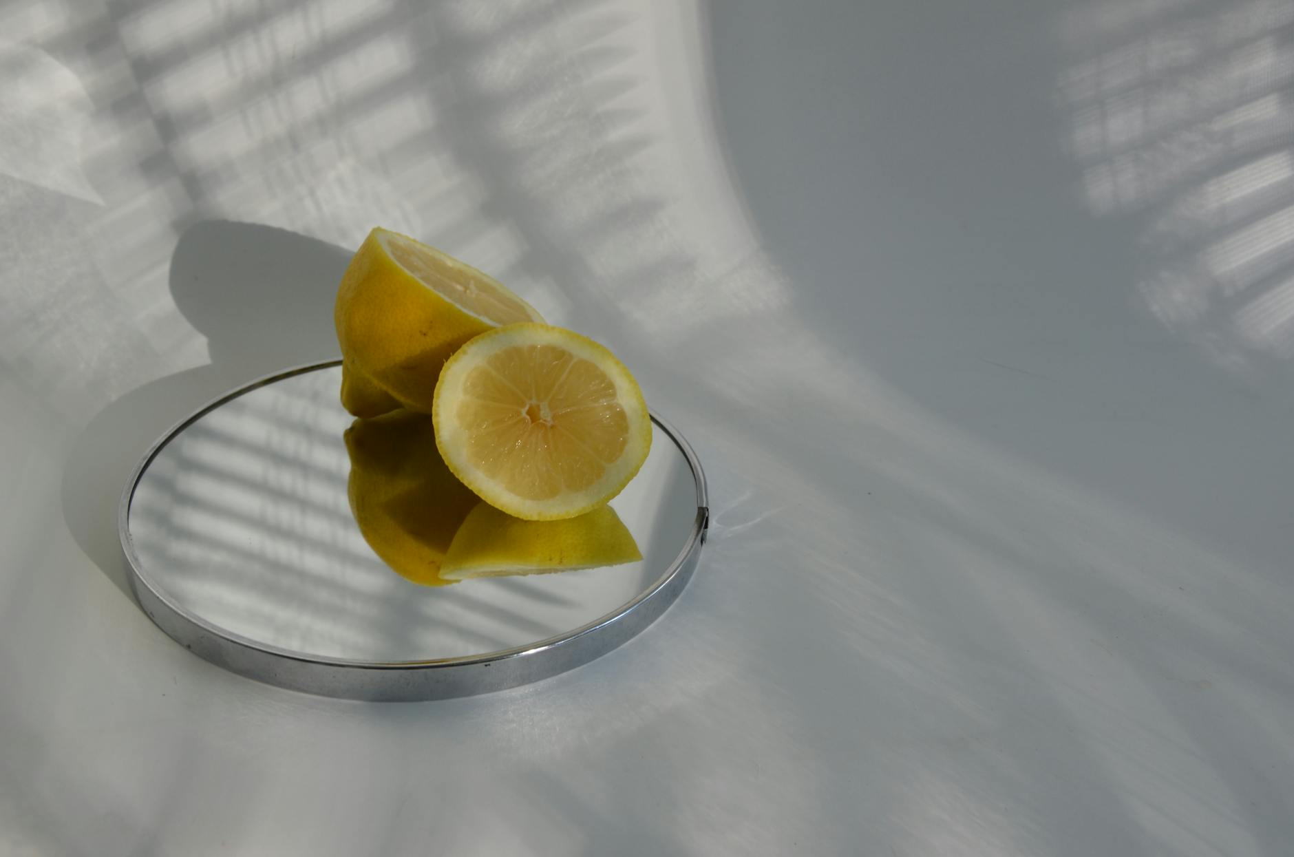 A yellow silicone vibrator surrounded by fresh lemons on a bright background, symbolizing comfort and discovery