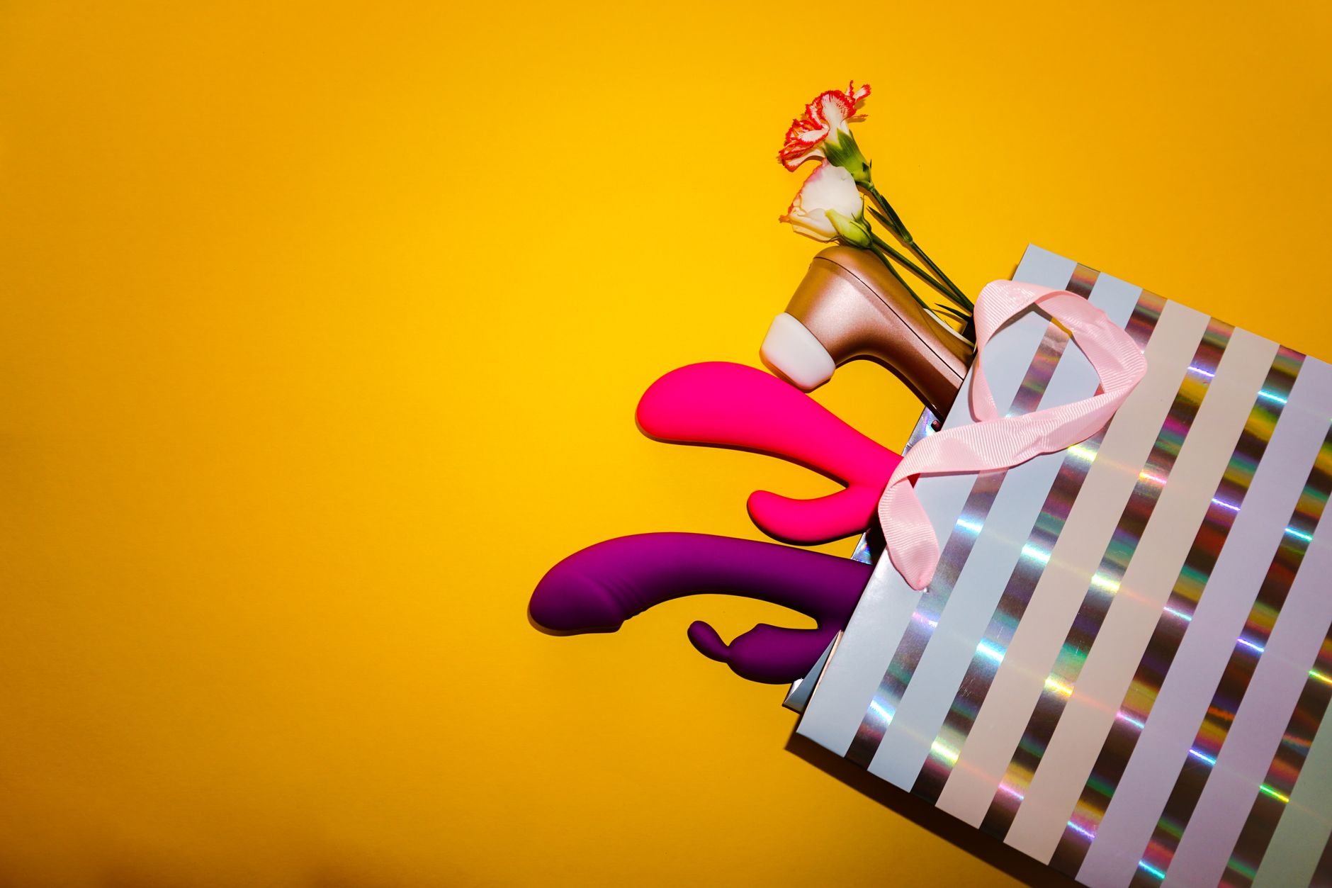 Yellow lemon vibrator surrounded by fresh lemons on a bright background