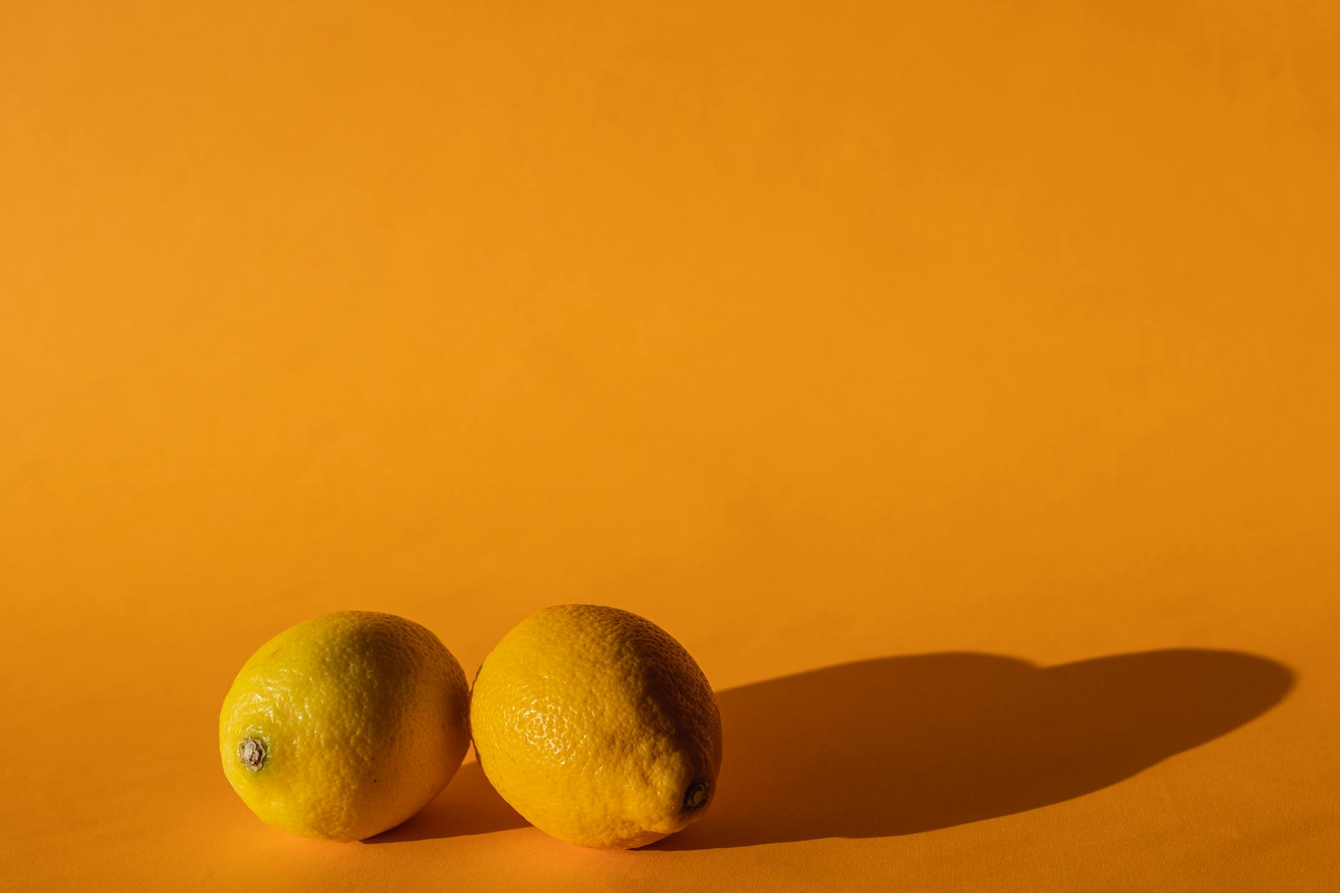 Vibrant lemons on a bright yellow background, symbolizing renewed sensation and pleasure recovery